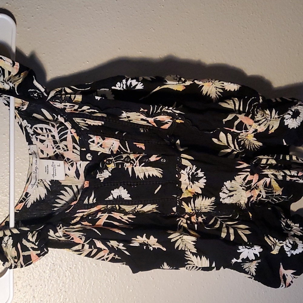 Medium black blouse with colorful leaves.